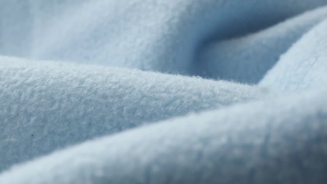 Shallow DOF blue blanket made of polar fleece 4K panning footage