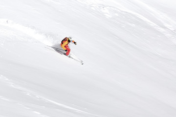 Fototapeta na wymiar One skier skiing downhill through fresh powder snow, no sky, white snow background