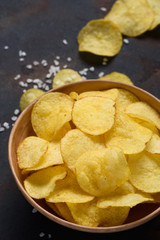Crispy potato chips with salt in bowl