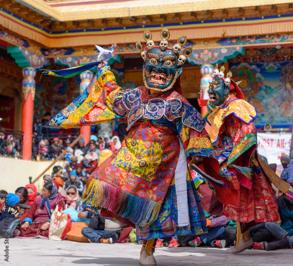 Wall mural buddhist monk with dragon mask dancing at colorful buddhism mask dance festival of matho in ladahk, 