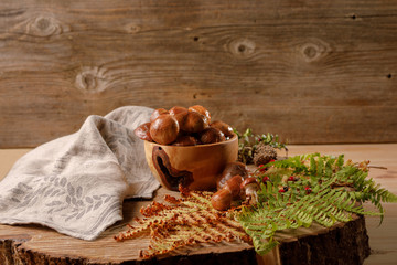 Fresh autumn mushrooms on a wooden background.