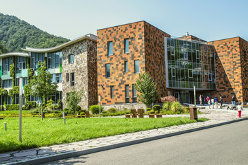 Fototapeta na wymiar The main entrance and glazed academic buildings of the international school-College in Dilijan nature reserve