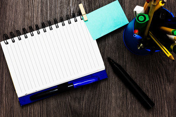 Design business concept Empty copy space modern abstract background. Open notebook clothespin holding reminder cup markers wooden background