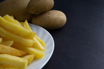 Potato fry on dark background with selective focus and crop fragment