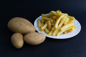 Potato fry on dark background with selective focus and crop fragment