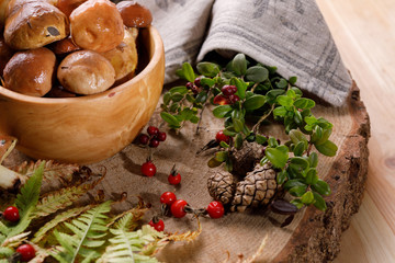 Autumn harvest of mushrooms. Still life on wooden background.