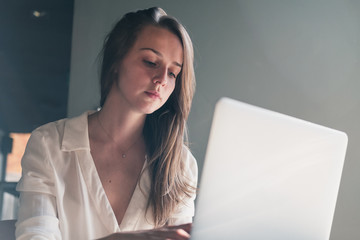 young woman working on laptop