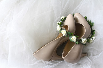 Wedding concept: a wreath of flowers and dress shoes