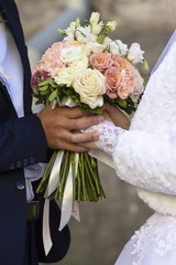 young happy wedding couple close with a bouquet