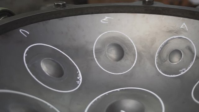Handpan on a construction tool in a musician workshop.