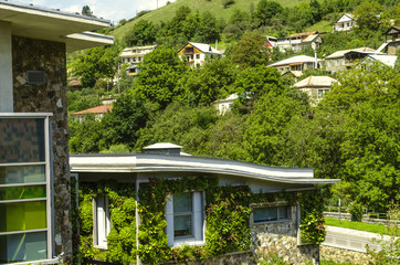 Fototapeta na wymiar Hill with houses in the suburbs of Dilijan near the academic buildings of the International College 