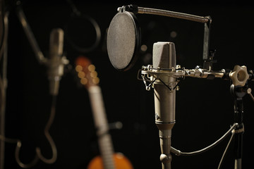 Fototapeta na wymiar Old Microphone in a Dark Recording Studio