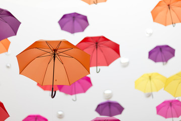 Conceptual installation of abstract background of beautiful colored umbrellas indoors.