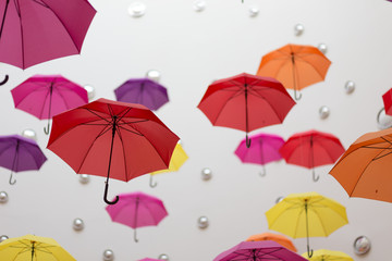 Conceptual installation of abstract background of beautiful colored umbrellas indoors.