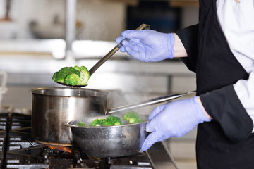 Chef at work in a restaurant kitchen making delicious food
