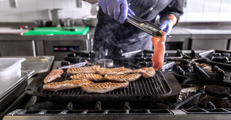 Chef in hotel or restaurant kitchen cooking
