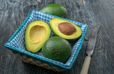 Photo avocado different positions on a black background, on a fabric