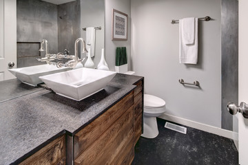 Luxurious bath with grey vanity cabinet.