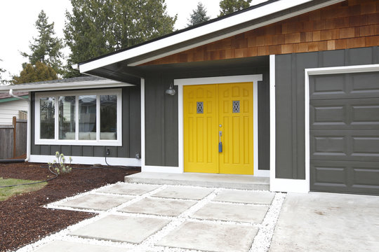 Home entrance with yellow front doors