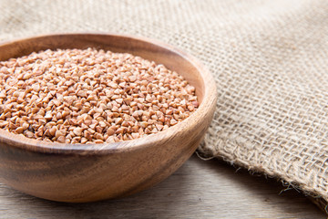 Bowl with Buckwheat on a wooden background