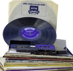 Anti-piracy advertising on the cover of an old vinyl record. A stack of old vinyl 33 rpm and some...