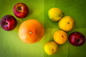 Fresh fruits on the green tablecloth