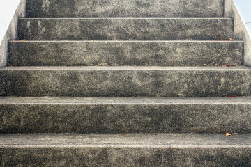Abstract background of concrete stairway. Surface of cement stair with small stone. Grunge texture of outdoor staircase. Low angle view step of stairs.