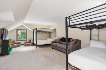 White and grey bunk room with vaulted ceiling