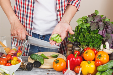 Woman cooks on the kitchen, soft focus background
