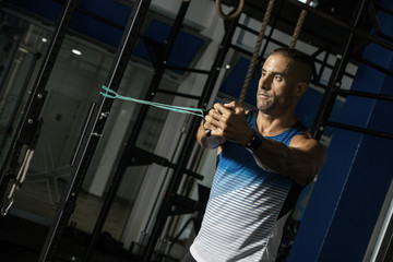 Athletic man training with resistance band