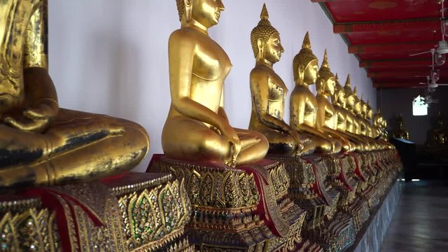 Golden Buddha Statues in the row at Wat Pho, Bangkok city, Thailand