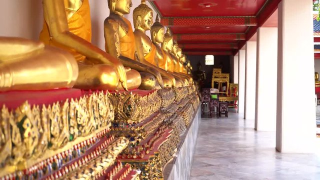Golden Buddha Statues in the row at Wat Pho, Bangkok city, Thailand