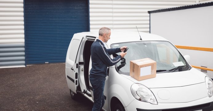 Delivery man using mobile phone