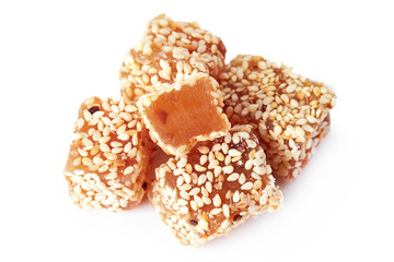 Dessert sweet Turkish delight (lokum) with sesame seeds isolated on white background