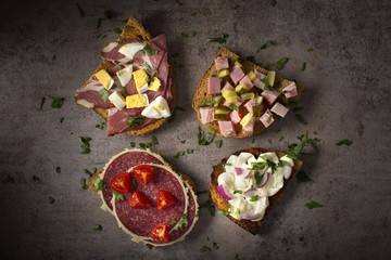 Set of open sandwiches with boiled eggs, cucumbers, salami, cheese and smoked meat