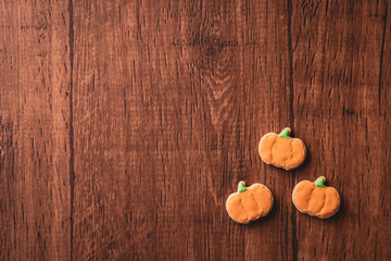 Fresh delicious homemade decorated halloween cookies sweets on dark wooden background, concept of halloween party, copy space(text space), top view, blank for text.