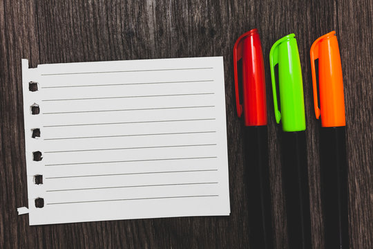 Design business Empty copy space text for Ad website promotion isolated Banner template. Colorful words with white page red green orange pen on blackish wooden desk