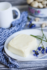 mozzarella cheese on a plate on a wooden background