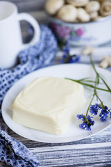 mozzarella cheese on a plate on a wooden background