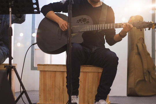 Guitarist on stage and sings in a concert for background, soft and blur concept