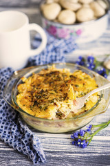 baked mashed potatoes with sausages and cheese in a plate