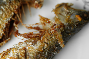 deep fried trevally fish on white plate