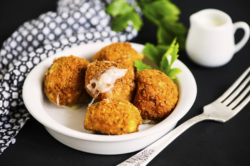 fried cheese balls with mozzarella on a plate