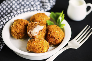 fried cheese balls with mozzarella on a plate