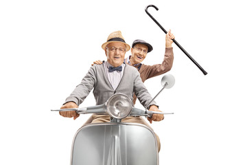 Two senior men on a scooter, one holding a cane