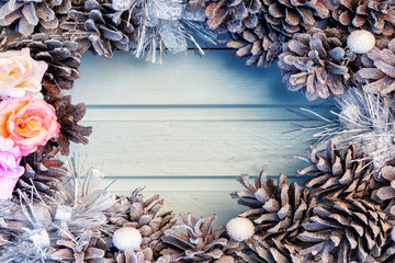 In the center of the Christmas composition of cones and flowers, an empty place for text, copy space.