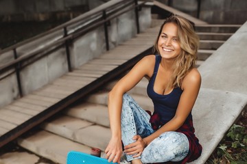 girl posing with skate board