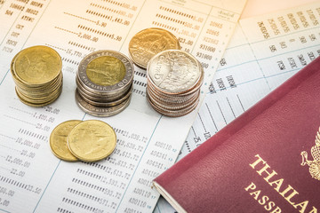 Thai coin on bookbank wiht Thai Passport concept saving money for travel