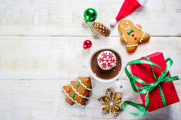 Christmas hot beverage ideas, girl drinking hot chocolate with marshmallow decorate with snowflake, hands in the picture, top view, copy space, with christmas decorations