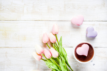 Girl drinking hot chocolate with marshmallows in the shape of hearts, Valentine's Day celebration, hands in the picture, top view, copy space